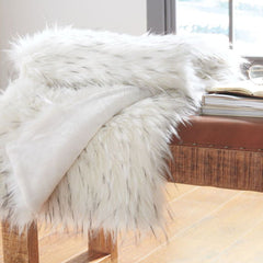 White Faux fur throw on bench