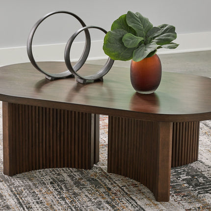 Korestone - Dark Brown - Oval Cocktail Table Signature Design by Ashley® 