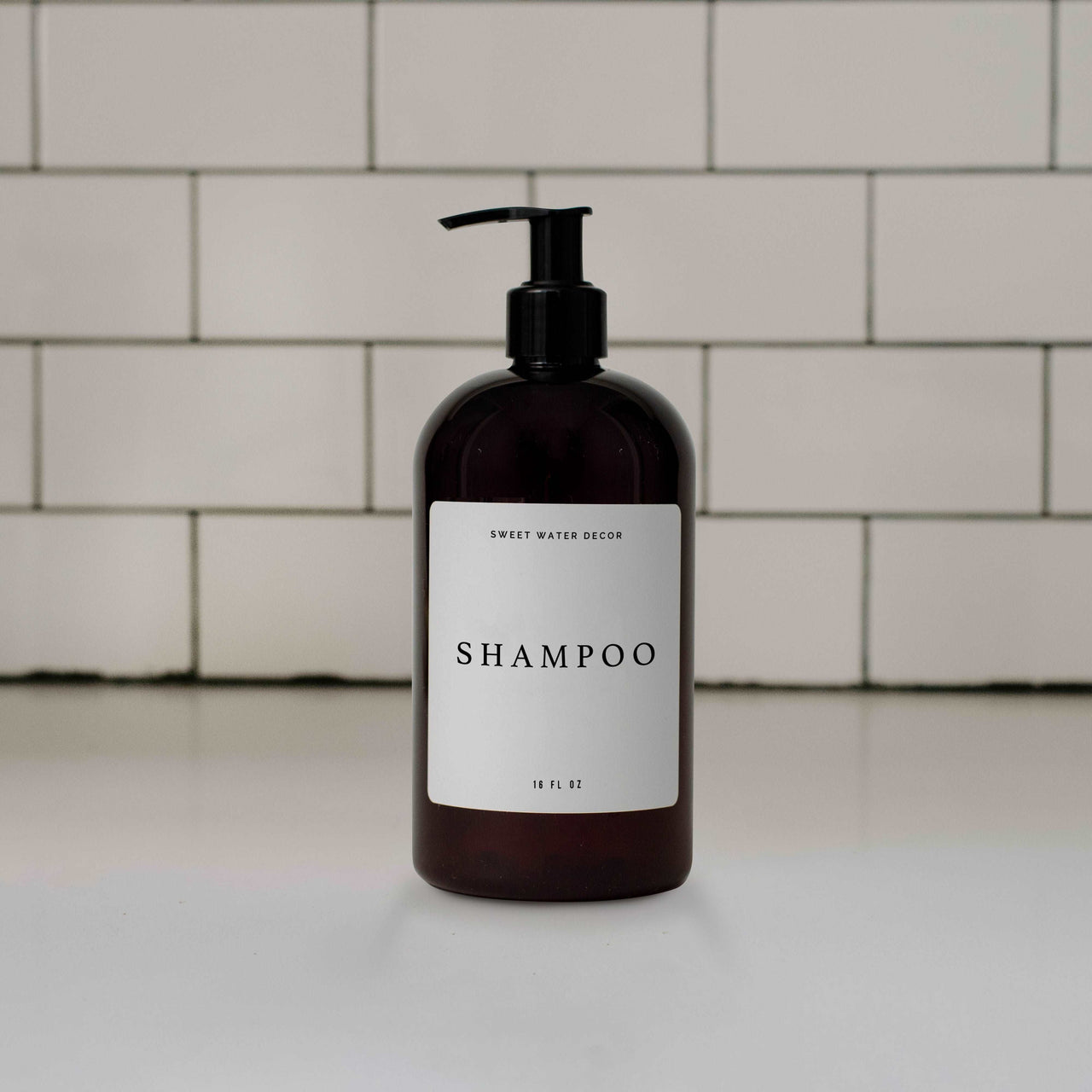 16oz Amber Plastic Shampoo Dispenser - White Text Label Tony's Home Furnishings Furniture. Beds. Dressers. Sofas.