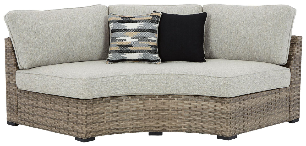 Calworth - Beige - Curved Loveseat With Cushion Tony's Home Furnishings Furniture. Beds. Dressers. Sofas.