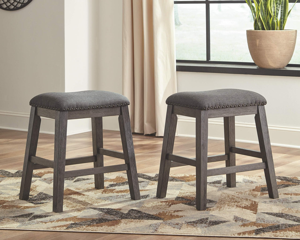 Caitbrook - Gray - Upholstered Stool (Set of 2) Tony's Home Furnishings Furniture. Beds. Dressers. Sofas.